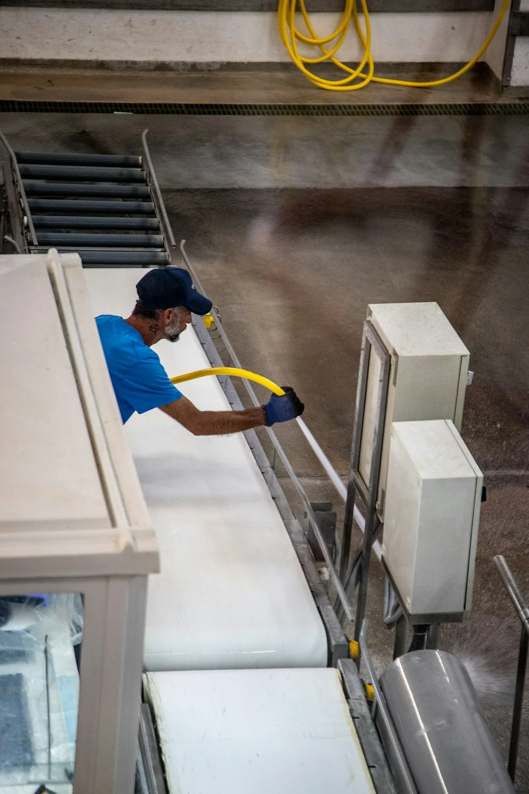 A worker in protective gear disinfects a kitchen, ensuring a clean and safe environment.